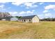 Back exterior view of a home with open land and trees in the distance at 8695 Freeze Rd, Kannapolis, NC 28081