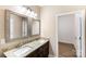 Bathroom with granite double vanity, large mirrors, and access to a walk-in closet at 8695 Freeze Rd, Kannapolis, NC 28081