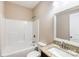 Bathroom with a shower/tub combo, granite vanity top, and a decorative mirror at 8695 Freeze Rd, Kannapolis, NC 28081