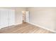 Bedroom with wood-look floors, white closet doors, and neutral walls at 8695 Freeze Rd, Kannapolis, NC 28081