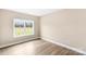 Unfurnished bedroom with wood-look floors and large windows offering natural light at 8695 Freeze Rd, Kannapolis, NC 28081