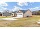 Side view of a single-story home with a two-car garage and a partially landscaped yard at 8695 Freeze Rd, Kannapolis, NC 28081