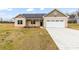 New construction home with a covered front porch, attached two-car garage, and front yard at 8695 Freeze Rd, Kannapolis, NC 28081