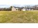 Front and side view of a house with a sloped front yard and a few trees in the background at 8695 Freeze Rd, Kannapolis, NC 28081