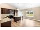 Modern kitchen with dark wood cabinetry, granite countertops, and stainless steel appliances at 8695 Freeze Rd, Kannapolis, NC 28081