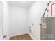 Bright laundry room with white walls, wood-look floors, and a water heater at 8695 Freeze Rd, Kannapolis, NC 28081