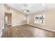 Living room with large window, wood-look flooring, and neutral-colored walls at 8695 Freeze Rd, Kannapolis, NC 28081