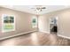 Spacious main bedroom with ensuite bath access, ceiling fan and wood floors at 8695 Freeze Rd, Kannapolis, NC 28081