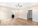 Main bedroom with ceiling fan, wood floors, and an ensuite bathroom and closet at 8695 Freeze Rd, Kannapolis, NC 28081