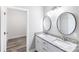 Double vanity bathroom featuring granite countertops, white cabinets, and oval mirrors at 8721 Freeze Rd, Kannapolis, NC 28081