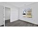 Bright bedroom with gray carpeting and large window at 938 Grassy Patch Ln, Charlotte, NC 28216