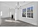 Spacious dining area with a chandelier and large window overlooking backyard at 938 Grassy Patch Ln, Charlotte, NC 28216