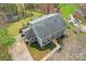 Aerial view of a gray two-story home with a gray roof, driveway, and landscaped yard at 14008 Creekside Dr, Matthews, NC 28105