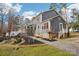 Exterior view of a two-story gray house with red trim, a deck, and landscaping at 14008 Creekside Dr, Matthews, NC 28105