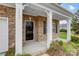 Front entrance with a black door and white columns at 3642 Savannah Hills Dr, Matthews, NC 28105