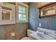 Bathroom with teal striped wallpaper and vintage vanity at 402 E Arch St, Lancaster, SC 29720