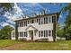 Two-story white house with black shutters, brick pathway, and lush green lawn at 402 E Arch St, Lancaster, SC 29720