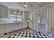 White kitchen with appliances, checkered floor and ample cabinet space at 402 E Arch St, Lancaster, SC 29720