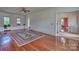 Large living room with hardwood floors, built-in shelving, and area rug at 402 E Arch St, Lancaster, SC 29720