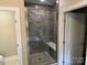 Walk-in shower with gray tile, a built-in bench, and a rainfall showerhead at 4031 Stadler Ne Dr # 21, Conover, NC 28613