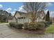 Side view showcasing stone exterior, landscaping, and a paved driveway at 4709 Polo Gate Blvd, Charlotte, NC 28216