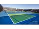 Pickleball courts with windscreen and benches, ready for a game at 511 Sunharvest Ln, Indian Trail, NC 28079