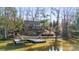 Aerial view of waterfront home with private dock and lush landscaping at 60 Sigmon Drum Rd, Hickory, NC 28601