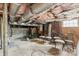 Unfinished basement with exposed brick walls, concrete floor, and some storage space at 707 Arlington Ave, Albemarle, NC 28001