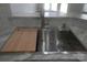 Stainless steel kitchen sink with a built-in cutting board at 8738 Fox Chase Ln, Charlotte, NC 28269