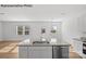 Modern kitchen island with granite countertop and double sink at 10003 Travis Floyd Ln # 050, Charlotte, NC 28214