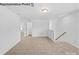 Living room with hardwood floors and access to the stairs at 10003 Travis Floyd Ln # 050, Charlotte, NC 28214
