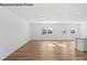 Open living room with hardwood floors and large windows at 10003 Travis Floyd Ln # 050, Charlotte, NC 28214