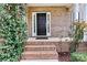 Brick front porch with black front door and lush greenery at 116 Diamond Head Dr, Mooresville, NC 28117