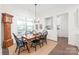 Formal dining room with a wooden table and black chairs at 128 Shimmer Lake Ln, Belmont, NC 28012