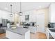 Modern kitchen with white cabinets, stainless steel appliances, and a large island at 1439 Glasscock Rd, Rock Hill, SC 29730