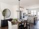 Open dining room with a wooden table and modern chandelier at 1526 Levy Way, Charlotte, NC 28205