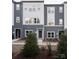 Three-story townhouses with gray and white siding at 1526 Levy Way, Charlotte, NC 28205