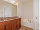 Bathroom boasts double sinks, a soaking tub, and wood cabinets at 16718 Dolcetto Way, Charlotte, NC 28277