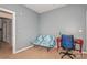 Bedroom with a sofa, desk, and built-in shelving at 16718 Dolcetto Way, Charlotte, NC 28277