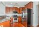 Modern kitchen with stainless steel appliances and wood cabinets at 16718 Dolcetto Way, Charlotte, NC 28277