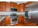 Kitchen with stainless steel appliances and wood cabinets at 16718 Dolcetto Way, Charlotte, NC 28277