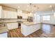 Modern kitchen with white cabinets, large island, and stainless steel appliances at 16744 Summers Walk Blvd, Davidson, NC 28036