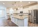 Modern kitchen with white cabinets, large island, and stainless steel appliances at 16744 Summers Walk Blvd, Davidson, NC 28036