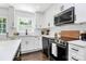 Updated kitchen with white shaker cabinets and stainless steel appliances at 2038 Sandhurst Dr, Charlotte, NC 28205