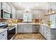 L-shaped kitchen with granite countertops and stainless steel appliances at 226 Hickory St, Locust, NC 28097