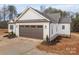 Brown garage door with white siding and landscaping at 2596 Maiden Salem Rd, Lincolnton, NC 28092