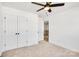 Well-lit bedroom featuring double doors and access to hallway at 3050 Swallowtail Ln, Kannapolis, NC 28083