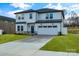 Two-story house with white siding, gray roof, and stone accents at 3050 Swallowtail Ln, Kannapolis, NC 28083