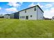 Rear view of a two story home with white siding and large grassy yard at 3050 Swallowtail Ln, Kannapolis, NC 28083
