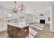 Spacious kitchen with island, white cabinets, and gold accents at 3050 Swallowtail Ln, Kannapolis, NC 28083